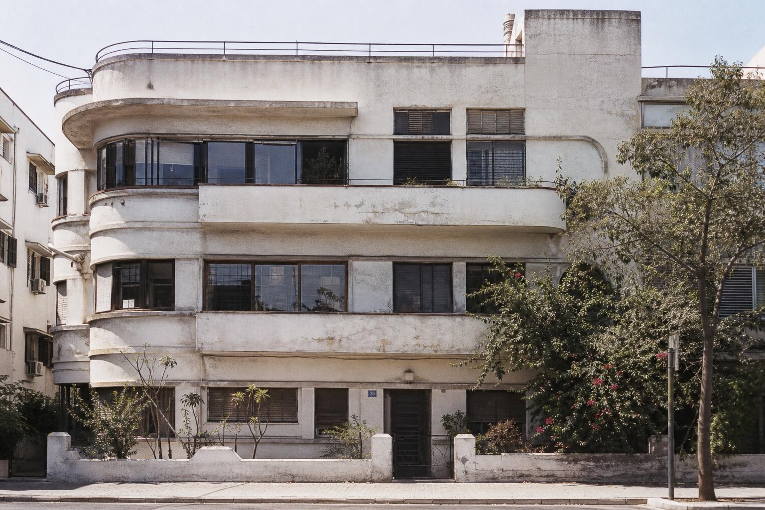Weathered Bauhaus-style Tel Aviv building before restoration